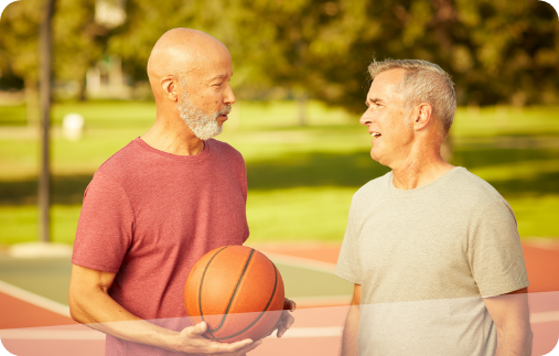 Photograph of two men talking engaged in friendly conversation with each other on a basketball court. Photograph of two men talking engaged in friendly conversation with each other on a basketball court.
